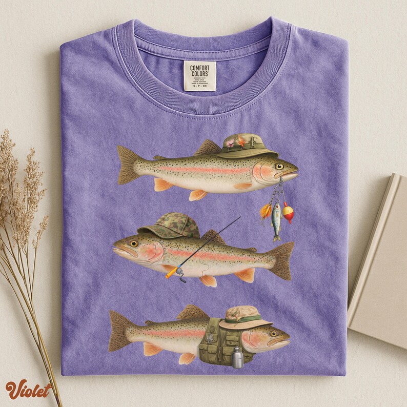 Violet Comfort Colors® shirt laid flat, printed with three trout dressed as fishermen, including hats, tackle, and a fishing vest.