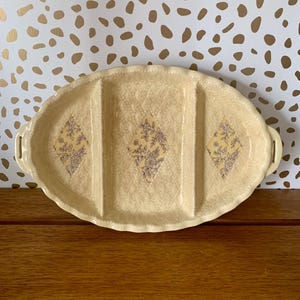 May include: A set of three ceramic mugs with a speckled, matte finish. The mugs are in shades of cream, light gray, and dark gray. Each mug has a simple, minimalist design and a rounded handle.