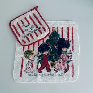 May include: A white and red striped Christmas-themed pot holder and towel set. The pot holder has the text "Twas the night before Christmas". The towel features a Christmas tree and children. The towel also has the text "Twas the night before Christmas".