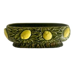 May include: A set of three ceramic mugs with a speckled, matte finish. The mugs are in shades of cream, light gray, and dark gray. Each mug has a simple, minimalist design and a rounded handle.