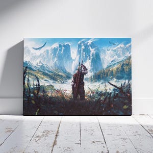 May include: Canvas art print featuring a figure with a sword, standing in a field, with a mountain range in the background. The artwork has a fantasy theme, with a blue sky and flying birds. The canvas is mounted on a wooden frame.