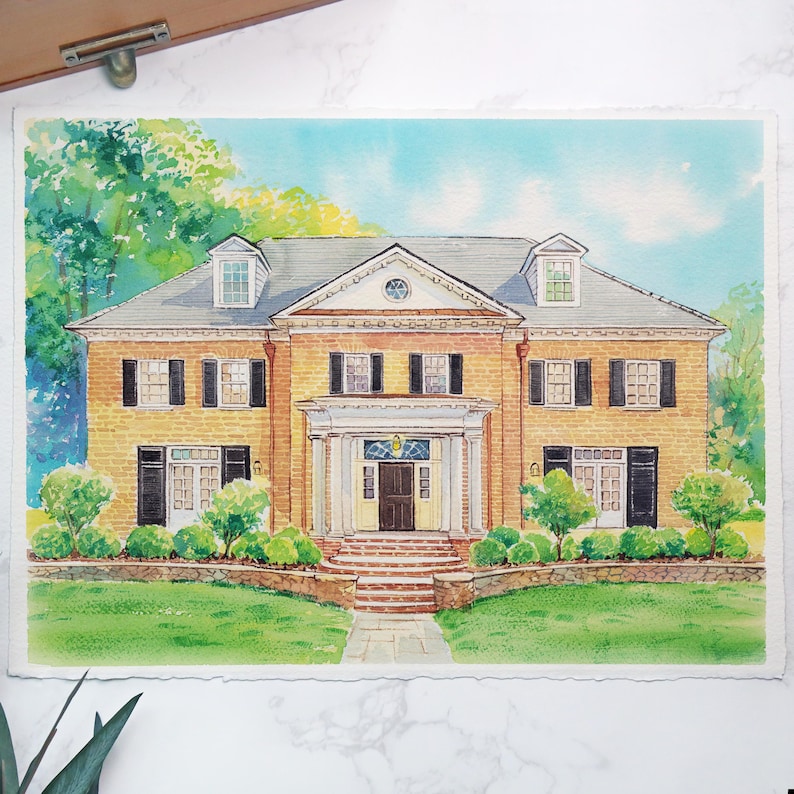 May include: Watercolor painting of a two-story house with a brick facade, black shutters, and a gray roof. The house has a symmetrical design with a central entrance and is surrounded by green landscaping and a blue sky.
