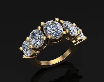 May include: A gold ring with five oval-cut diamonds. The diamonds are set in a row, with the largest diamond in the center. The ring has a polished finish and is set against a black background.
