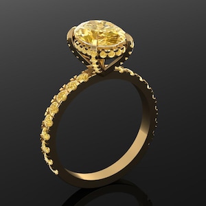 May include: A gold ring with a large, oval yellow gemstone. The band is adorned with smaller yellow stones. The ring is set against a dark background, highlighting its intricate design and sparkle. A piece of jewelry.