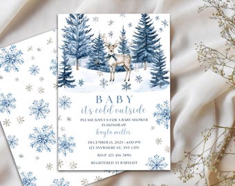May include: Baby shower invitation with a winter theme. The design features a watercolor illustration of a deer in a snowy forest with blue pine trees and snowflakes. The text reads "BABY it's cold outside".