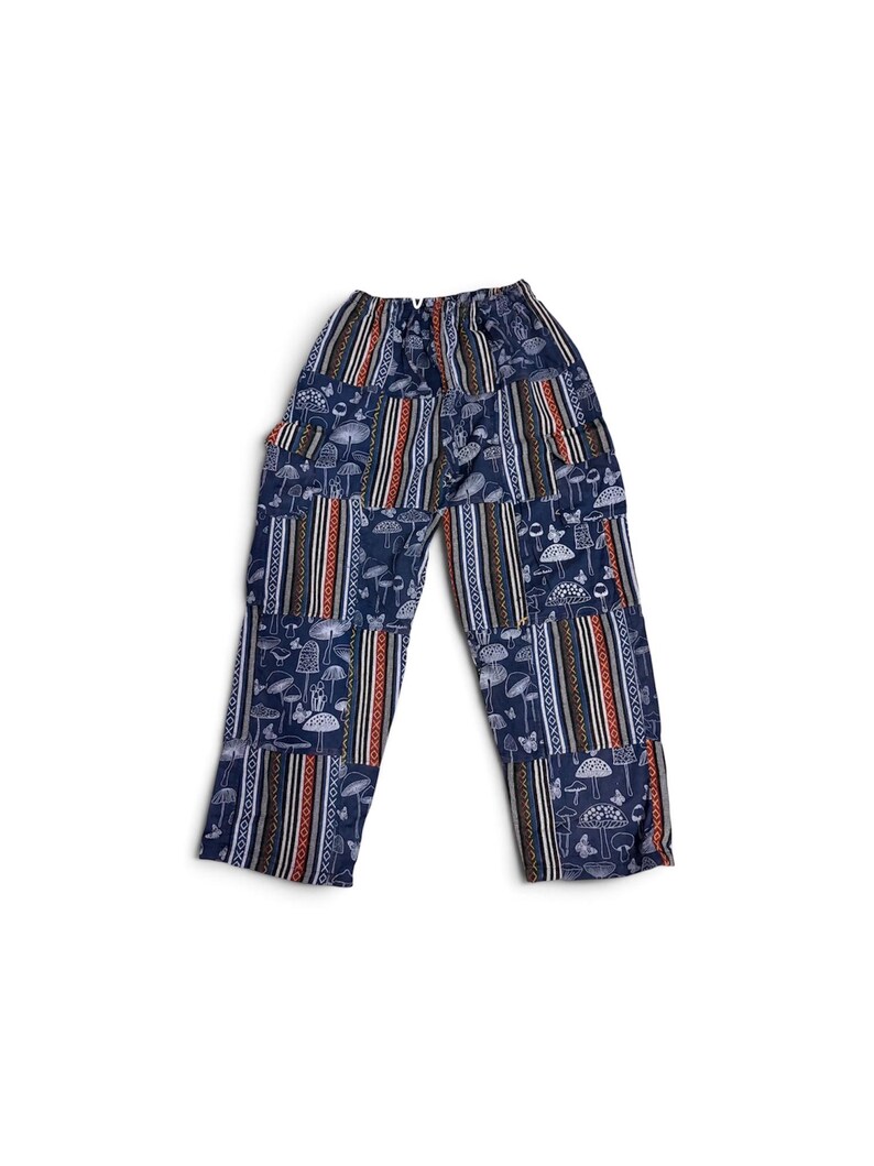 May include: Navy blue trousers featuring a patchwork design with alternating panels. One panel type displays a white line-art pattern of various mushrooms and butterflies, while the other features vertical stripes in orange, white, and black.