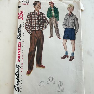 May include: A Simplicity printed pattern envelope, number 4452, size 8. The white paper envelope features illustrations of three outfits: a plaid jacket with brown trousers, a green jacket with tan trousers, and a gray jacket with blue shorts.