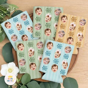 May include: A collection of beverage can coolers with a repeating pattern of smiling baby faces and the text "BEST DADDY EVER" in a bold font. The coolers are in various pastel colors, including blue, green, and tan.