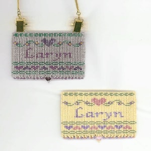 May include: Two beaded name tags. One is lavender with the name "Laryn" in purple, green, and gold beads. The other is yellow with the name "Laryn" in purple beads and a pink heart. Both have a beaded border.