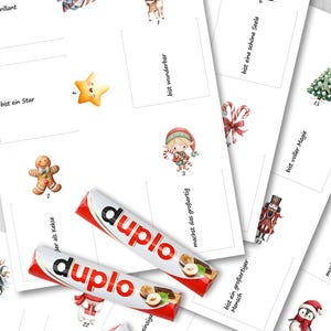 May include: A collection of Christmas-themed cards with illustrations of a reindeer, Santa Claus, and a gingerbread man. The cards are accompanied by several Duplo chocolate bars. The cards have German text and numbers.