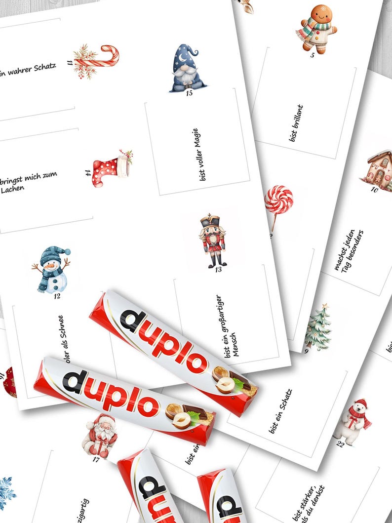 Puede incluir: Una colecci&oacute;n de tarjetas blancas con ilustraciones de acuarela de tem&aacute;tica navide&ntilde;a, incluyendo un mu&ntilde;eco de nieve, un hombre de jengibre y Pap&aacute; Noel. Tambi&eacute;n se ven dos barras de chocolate Duplo, con envoltorios rojos y blancos.