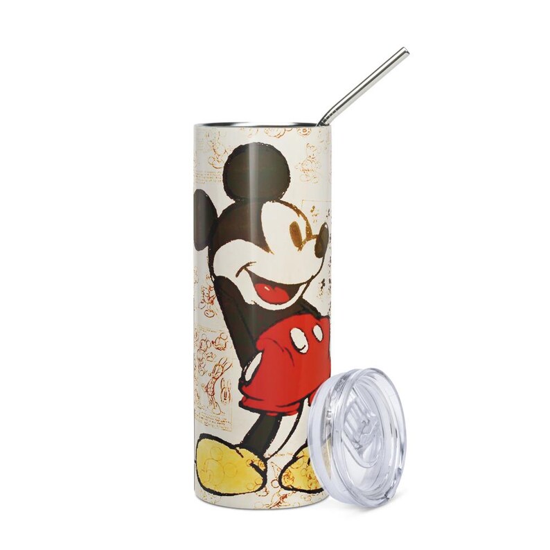 May include: A cylindrical stainless steel tumbler featuring a vintage-style illustration of Mickey Mouse with red shorts and yellow shoes. The background includes faint sketches, and the tumbler comes with a clear plastic lid and a metal straw.
