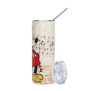 May include: A cylindrical stainless steel tumbler featuring a vintage-style Mickey Mouse graphic in red, black, and yellow on a cream background. The design includes multiple small sketches, the text Mickey Mouse, and Sorcerer Apprentice. Includes a lid and straw.
