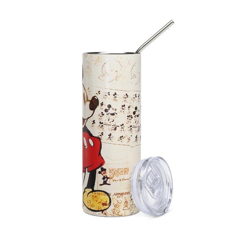 May include: A cylindrical stainless steel tumbler featuring a vintage-style Mickey Mouse graphic in red, black, and yellow on a cream background. The design includes multiple small sketches, the text Mickey Mouse, and Sorcerer Apprentice. Includes a lid and straw.
