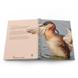 May include: An open hardcover book featuring a red-necked grebe on the right cover and text on the left. The spine reads GOULD RED-NECKED GREBE 1862-1873. The back cover includes the text The Birds of Great Britain and the Character Studio logo.