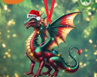 May include: A Christmas ornament featuring a red, green, and gold dragon wearing a Santa hat with the name "MATEO". The dragon is adorned with colorful lights and has a red ribbon for hanging. The ornament is labeled "2D FLAT ITEM".