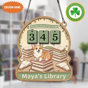 May include: Wooden sign with a corgi sitting on books, with the text "BOOKS READ THIS YEAR" and the numbers "345". The sign also includes the text "Maya's Library" and a shamrock logo.