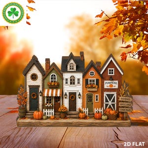 Puede incluir: Un expositor decorativo de mesa con una hilera de cinco casas en miniatura en colores otoñales, como blanco, verde, naranja y marrón. Las casas están adornadas con calabazas, follaje otoñal y letreros que dicen PUMPKINS, HAYRIDES, APPLE CIDER y CORN MAZE.