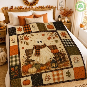 May include: A patchwork quilt featuring a central illustration of a ghost wearing a plaid scarf sitting on a wooden bench surrounded by pumpkins and autumn leaves. The border consists of squares with patterns of plaid, polka dots, and foliage.