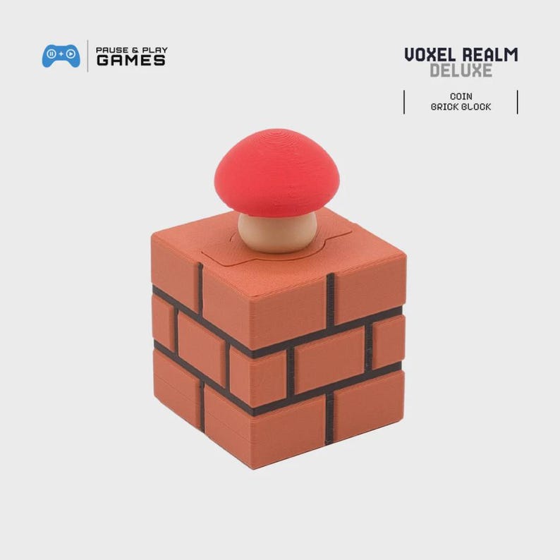 May include: A brick block toy with a red mushroom on top. The block is made of orange bricks with black lines. The text "VOXEL REALM DELUXE" is visible. The words "COIN" and "BRICK BLOCK" are also visible.