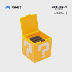 May include: A yellow Voxel Realm Deluxe cartridge question block with a hinged lid, open to reveal several game cartridges. The block features white question mark designs on the sides. The Pause & Play Games logo is in the upper left corner.
