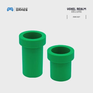 May include: Two green pipe-shaped objects, one larger than the other, are displayed against a light background. The pipes have a classic design, with a wide rim at the top. The text "VOXEL REALM DELUXE" and "PIPE SET" are visible.
