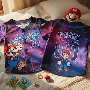 May include: Two baseball jerseys with a galaxy print featuring the character Mario. One jersey has "Mario 00" on the front, the other has "NAME 00". A Mario plush toy and game cards are also visible.