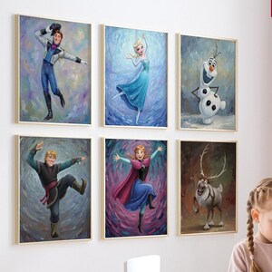 May include: Six framed art prints featuring characters from a popular animated film. The artwork includes images of a princess in a blue dress, a snowman, and other characters. The prints are displayed on a white wall.