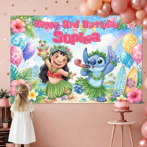 May include: A rectangular backdrop featuring a tropical beach scene with Lilo and Stitch characters, pink hibiscus flowers, surfboards, and balloons. The text reads Happy 3rd Birthday Sophia in pink lettering against a blue sky with a rainbow.