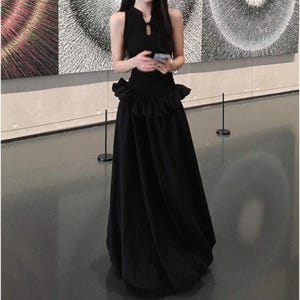 Women's Gothic Bodycon Maxi Dress | Sleeveless Ruffle Patchwork Gown | Elegant Vintage Grunge Y2K Fashion
.
A sleeveless women's bodycon maxi dress featuring ruffled patchwork details and a long flowing skirt, styled with gothic vintage and grunge Y2K fashion elements for an elegant, dark aesthetic.