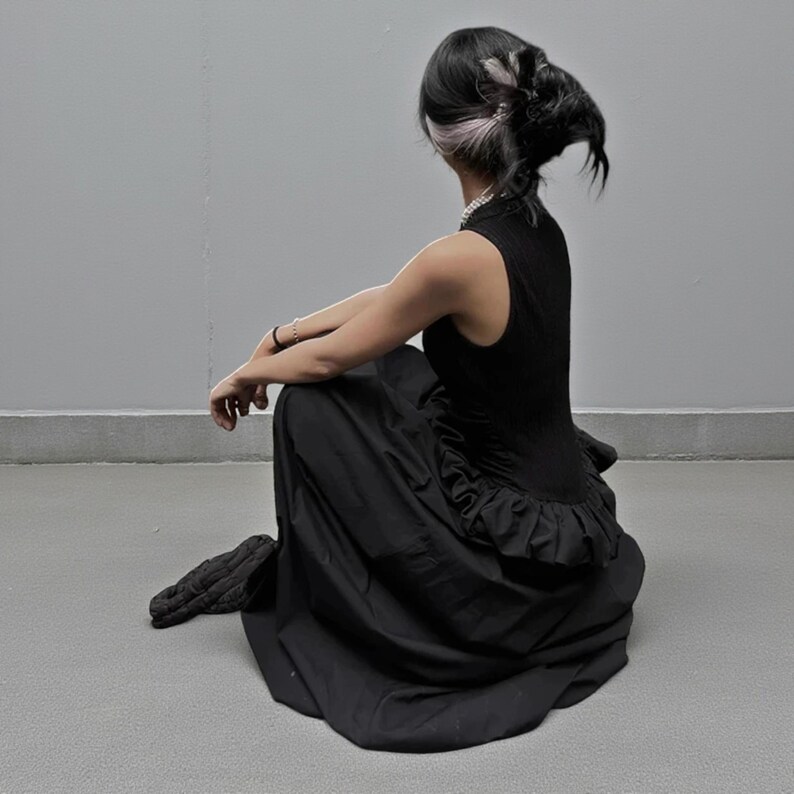 Women's Gothic Bodycon Maxi Dress | Sleeveless Ruffle Patchwork Gown | Elegant Vintage Grunge Y2K Fashion
.
A sleeveless women's bodycon maxi dress featuring ruffled patchwork details and a long flowing skirt, styled with gothic vintage and grunge Y2K fashion elements for an elegant, dark aesthetic.