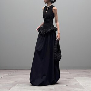 Women's Gothic Bodycon Maxi Dress | Sleeveless Ruffle Patchwork Gown | Elegant Vintage Grunge Y2K Fashion
.
A sleeveless women's bodycon maxi dress featuring ruffled patchwork details and a long flowing skirt, styled with gothic vintage and grunge Y2K fashion elements for an elegant, dark aesthetic.