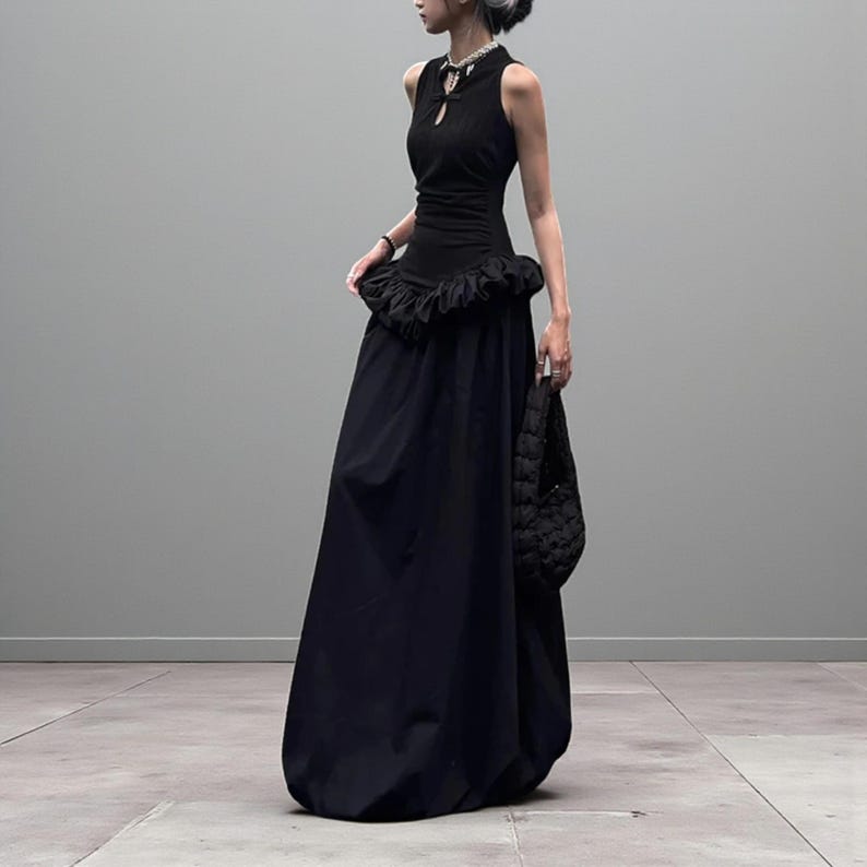 Women's Gothic Bodycon Maxi Dress | Sleeveless Ruffle Patchwork Gown | Elegant Vintage Grunge Y2K Fashion
.
A sleeveless women's bodycon maxi dress featuring ruffled patchwork details and a long flowing skirt, styled with gothic vintage and grunge Y2K fashion elements for an elegant, dark aesthetic.