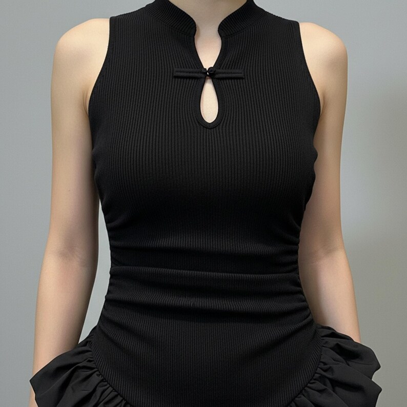 Close-up detail of the ribbed bodice, keyhole halter neckline, and ruffled patchwork waist on the black gothic maxi dress.