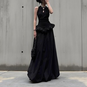 Women's Gothic Bodycon Maxi Dress | Sleeveless Ruffle Patchwork Gown | Elegant Vintage Grunge Y2K Fashion
.
A sleeveless women's bodycon maxi dress featuring ruffled patchwork details and a long flowing skirt, styled with gothic vintage and grunge Y2K fashion elements for an elegant, dark aesthetic.