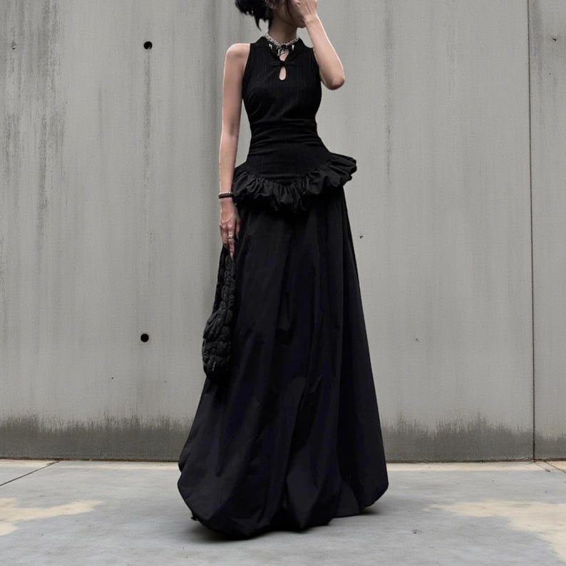 Women's Gothic Bodycon Maxi Dress | Sleeveless Ruffle Patchwork Gown | Elegant Vintage Grunge Y2K Fashion
.
A sleeveless women's bodycon maxi dress featuring ruffled patchwork details and a long flowing skirt, styled with gothic vintage and grunge Y2K fashion elements for an elegant, dark aesthetic.