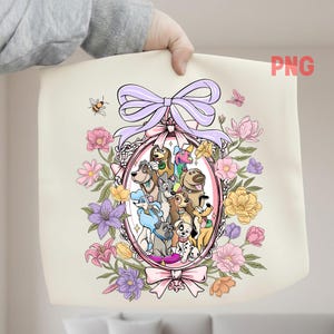 May include: A cream-colored tote bag featuring a cartoon illustration of various dog breeds within a pink oval frame, surrounded by colorful flowers and a lavender bow. A bee and butterfly are also present.