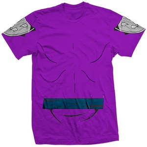 May include: Purple t-shirt with a stylized design resembling a superhero costume. The shirt features a blue belt, black lines outlining the torso, and silver shoulder pads. This graphic tee is a fun and unique apparel item.