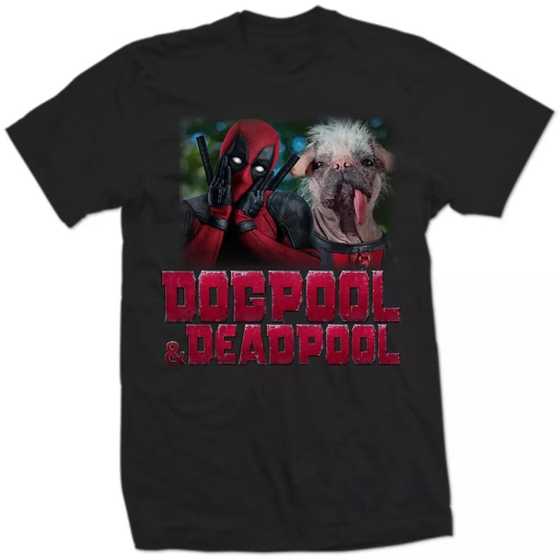 May include: Black t-shirt with a graphic of Deadpool and a dog. The image shows Deadpool in his red and black costume, with the dog next to him. The text "Dogpool & Deadpool" is printed in red.