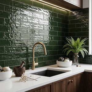 May include: A kitchen with dark green subway tile backsplash, a gold faucet, and a black sink. The countertop is white, and the cabinets are dark wood. A fern is in a glass vase, and a bowl of artichokes and onions sits on the counter.