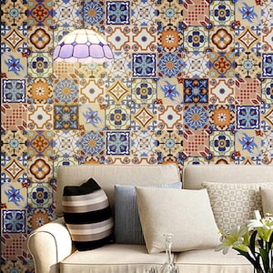 May include: A cream sofa with cushions against a wall of patterned tiles. The tiles display floral and geometric designs in blue, orange, and beige. A stained glass lamp hangs above the sofa, adding a decorative touch.