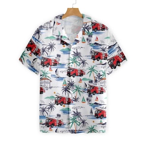 May include: White short-sleeve button-down shirt with a tropical print featuring red fire trucks, palm trees, sailboats, and beach scenes. The shirt has a classic collar and is made of a lightweight fabric.