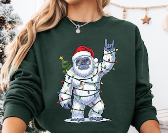 Lustiges Santa Bigfoot Weihnachtsbaum-Sweatshirt, Sasquatch eingewickelt in Weihnachtslichter-Feiertags-T-Stück, lustiges Weihnachtscryptid-Hemd