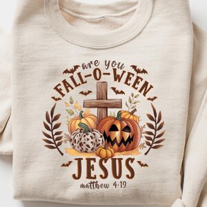 May include: Beige sweatshirt with a Fall-O-Ween graphic. The design features pumpkins, a cross, and the text "are you Fall-O-Ween Jesus Matthew 4:19". The sweatshirt has long sleeves and a crew neck.