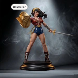 May include: A Wonder Woman statue, holding a golden shield and a sword, in a dynamic pose. She wears a red and blue costume with a gold belt and brown boots. The statue is on a black base, with a "Bestseller" label.