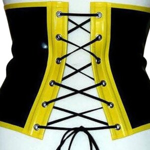 May include: Black and yellow latex corset with a lace-up back. The corset has a yellow trim and black laces.
