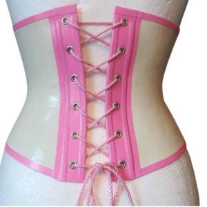May include: A white latex corset with pink trim and a lace-up back. The corset has a smooth, shiny finish.