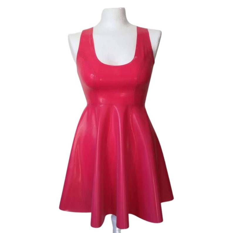 A sleeveless, pink latex dress with a scoop neck and a flared skirt.