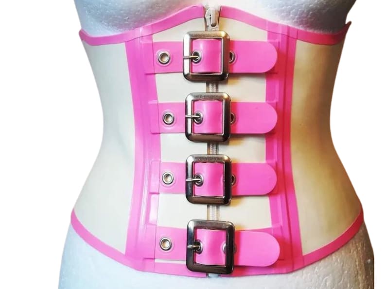 May include: White latex corset with pink trim and four silver buckles. The corset has a zipper closure in the back.