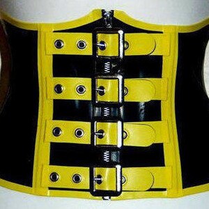May include: A black and yellow latex corset with multiple adjustable buckles. The corset has a zipper closure in the front.